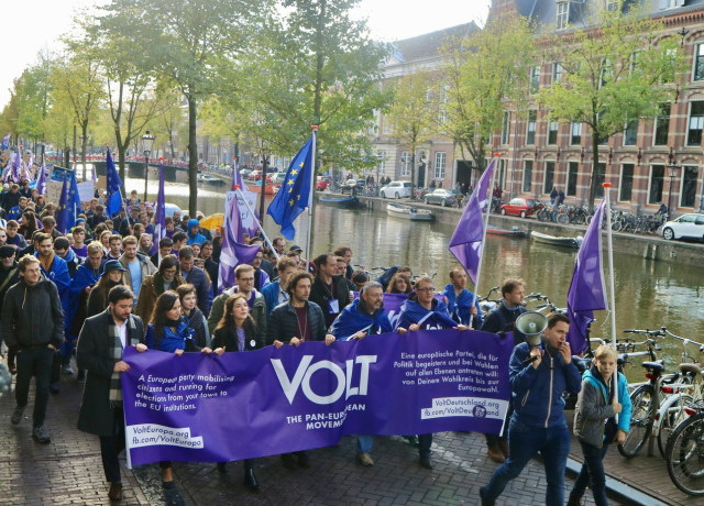 Volt parade in Amsterdam with flag