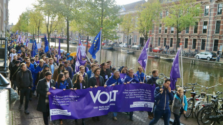 Volt parade in Amsterdam with flag